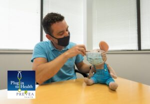 man covers the stuff toy with mask